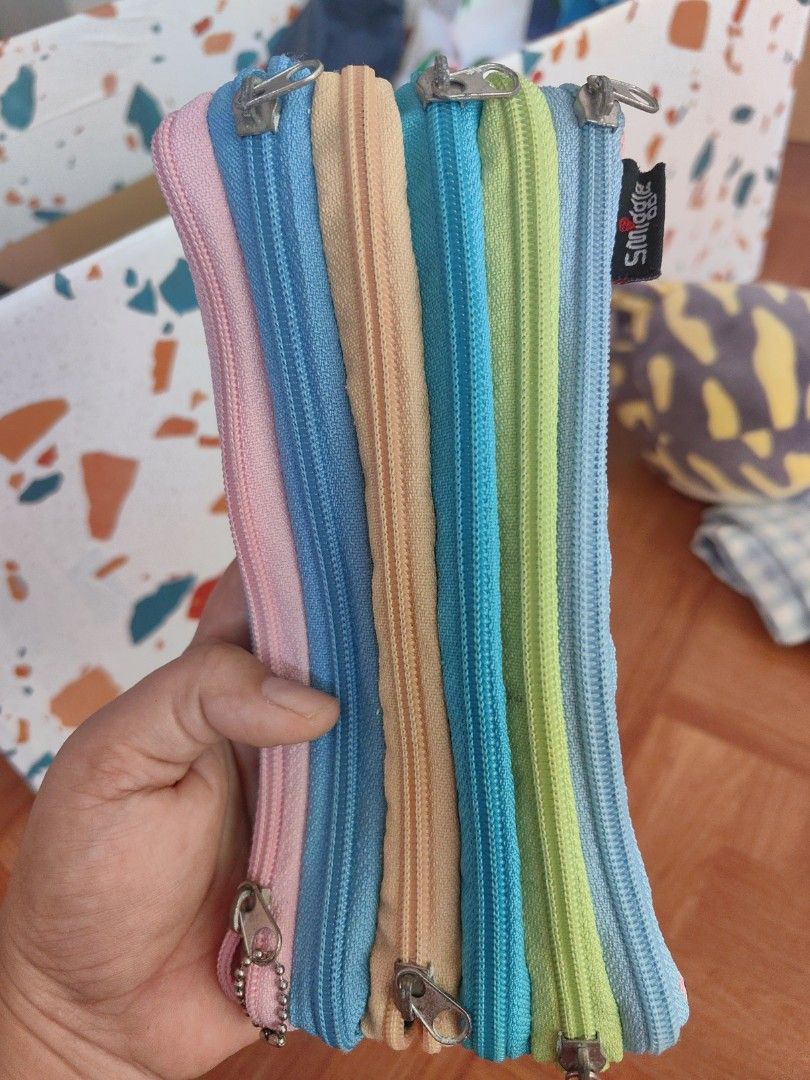 Smiggle Multi-Compartment Pencil Case (Category: Stationery & School Supplies) located in Zamboanga. Submitted by momglp (Listing ID 1425878860, Image 2). Description: Smiggle pencil case features multiple compartments with colorful zippers. The pencil case has a variety of pastel colors, including blue, green, yellow, and pink. It has a small Smiggle tag on the side..