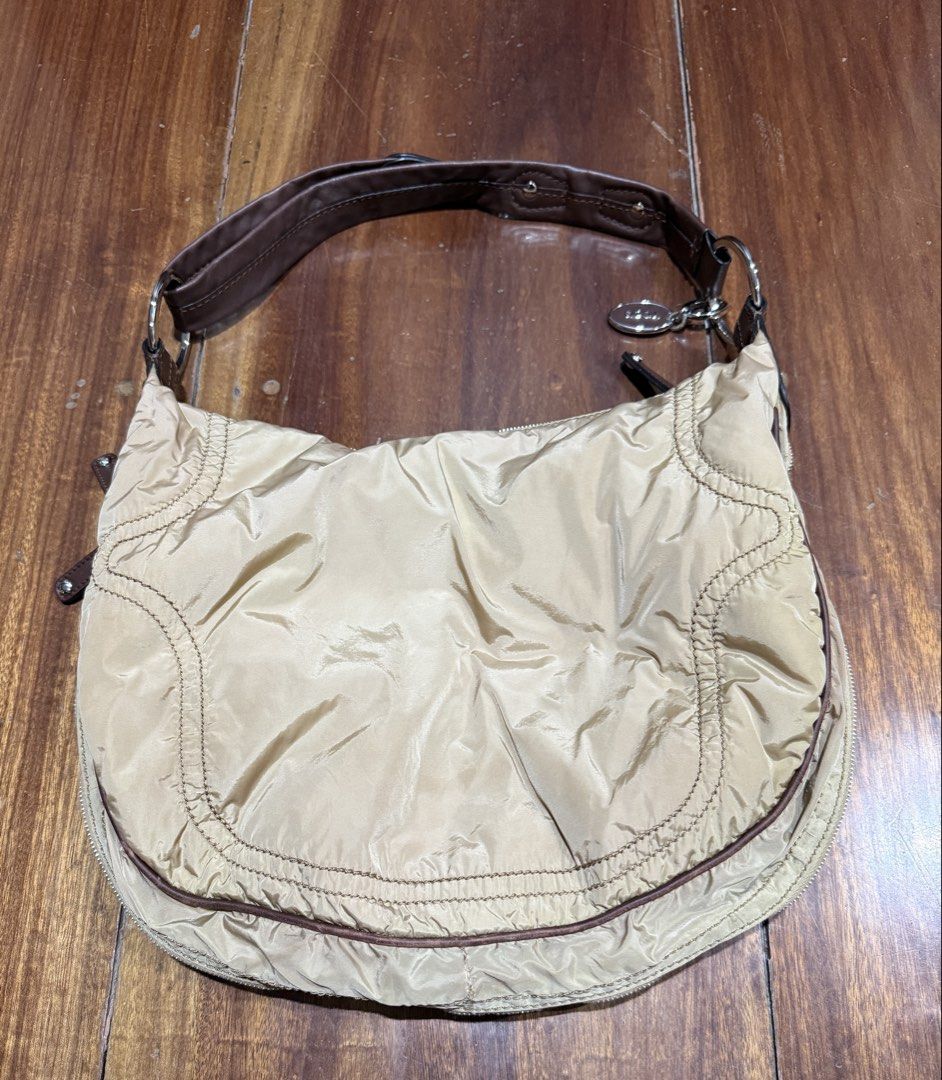 Tod's Luna Nylon Media Bag (Category: Luxury Bags & Wallets) located in Quezon City. Submitted by enidee (Listing ID 1425948467, Image 2). Description: -lightweight, nylon body with leather trims - multiple exterior zippered pockets -shoulder or crossbody bag -adjustable strap -wrap-around zipper to expand the bag’s capacity. -light discoloration on sides Please see photos for actual condition of the bag.