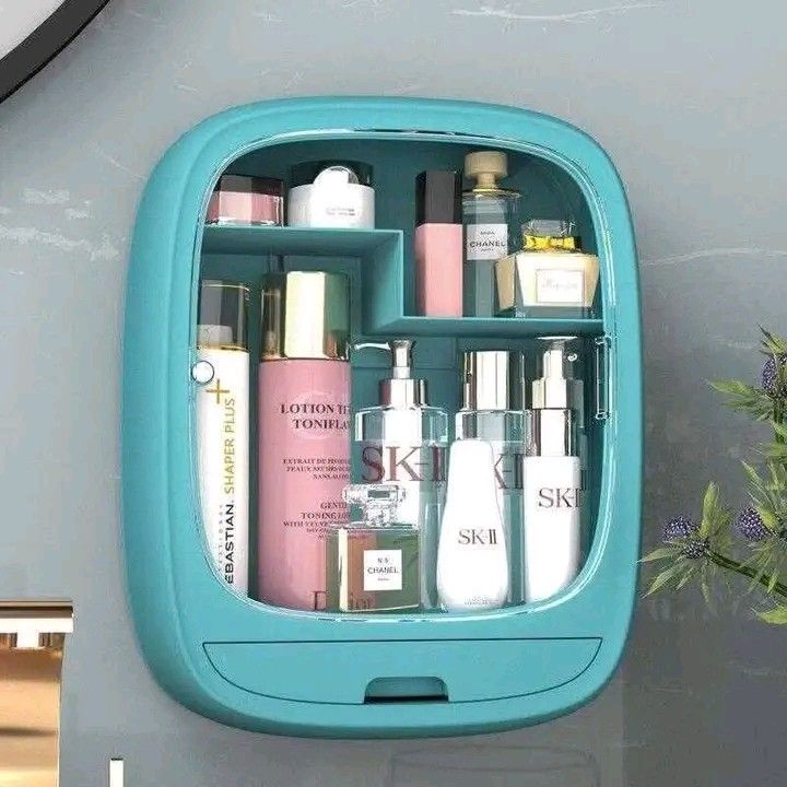 Wall-Mounted Cosmetic Organizer (Category: Makeup) located in Manila. Submitted by legitseller_angel06 (Listing ID 1425857971, Image 2). Description: Wall-mounted cosmetic organizer features multiple compartments and a drawer for storing various beauty products. It has a clear door for easy visibility and protection. The organizer is available in pink and blue. It is designed to save space and keep your cosmetics neatly organized. Dimensions are 