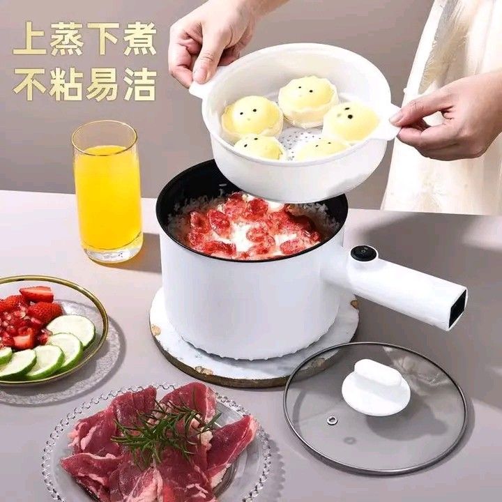 1.5L Multifunction Electric Cooker with Steamer (Category: Cookers) located in Manila. Submitted by legitseller_angel06 (Listing ID 1426034355, Image 2). Description: 1.5L electric cooker is perfect for steaming and cooking. It features a non-stick inner pot and a steamer basket. It has dual power settings and a glass lid. The cooker is white with a black interior. It's ideal for small meals and easy to clean..