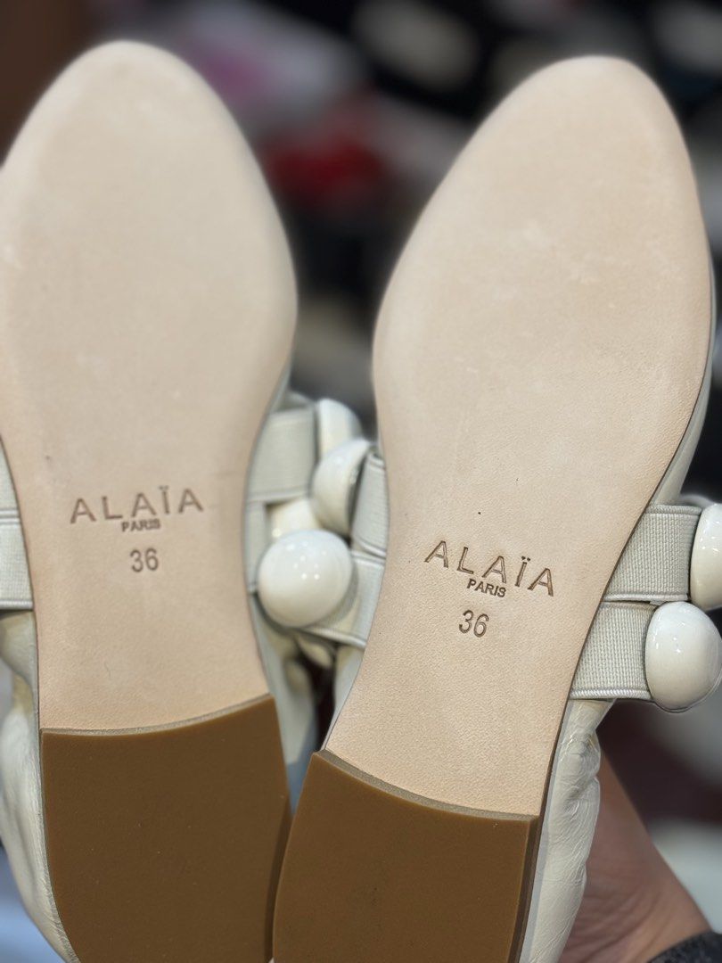 Alaïa White Ballerina Flats Size 36 (Category: Sneakers & Footwear) located in Manila. Submitted by thebodega88 (Listing ID 1426069494, Image 3). Description: Elegant Alaïa ballerina flats in white. Features a unique design with decorative white spheres on the straps. The flats are size 36. The Alaïa logo is visible on the insole and sole. These flats offer a stylish and comfortable fit. NO ISSUE VERY COMFORTABLE PRELOVE CHEAPEST ALAIA IN THE MAR
