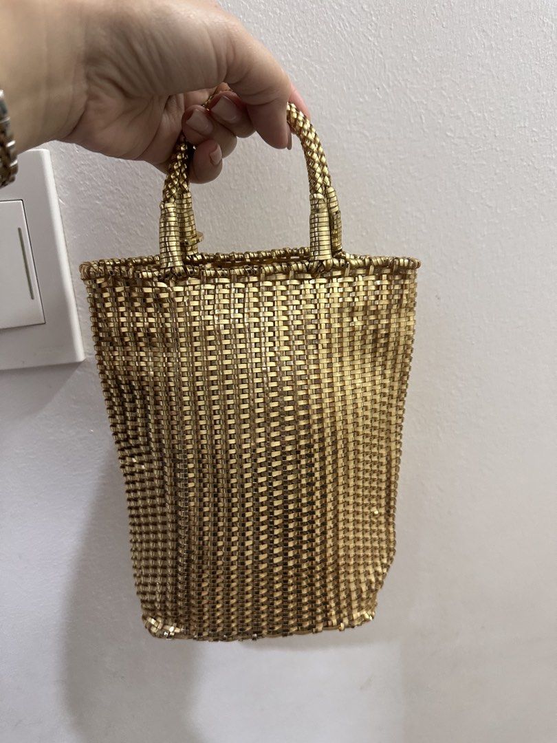 ANTEPRIMA Gold Woven Handbag (Category: Luxury Bags & Wallets) located in Valenzuela. Submitted by mommyiish (Listing ID 1426029920, Image 1). Description: Elegant gold woven handbag by ANTEPRIMA. Features a structured design with a woven handle. The bag has a cylindrical shape. The ANTEPRIMA logo is visible on the handle. A stylish accessory for any occasion..