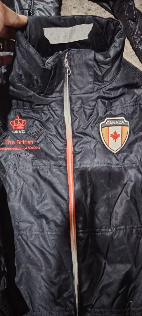 Assorted Jackets - Great Britain, Kappa, Canada (Category: Coats, Jackets and Outerwear) located in Marikina City. Submitted by laugh.thrift (Listing ID 1426115437, Image 3). Description: Collection of assorted jackets. One jacket features "Great Britain" on the front. Another jacket has a Kappa logo. A third jacket displays a "Canada" patch. All jackets appear to be black. They have zippers and pockets. Some jackets have hoods. The jackets are s