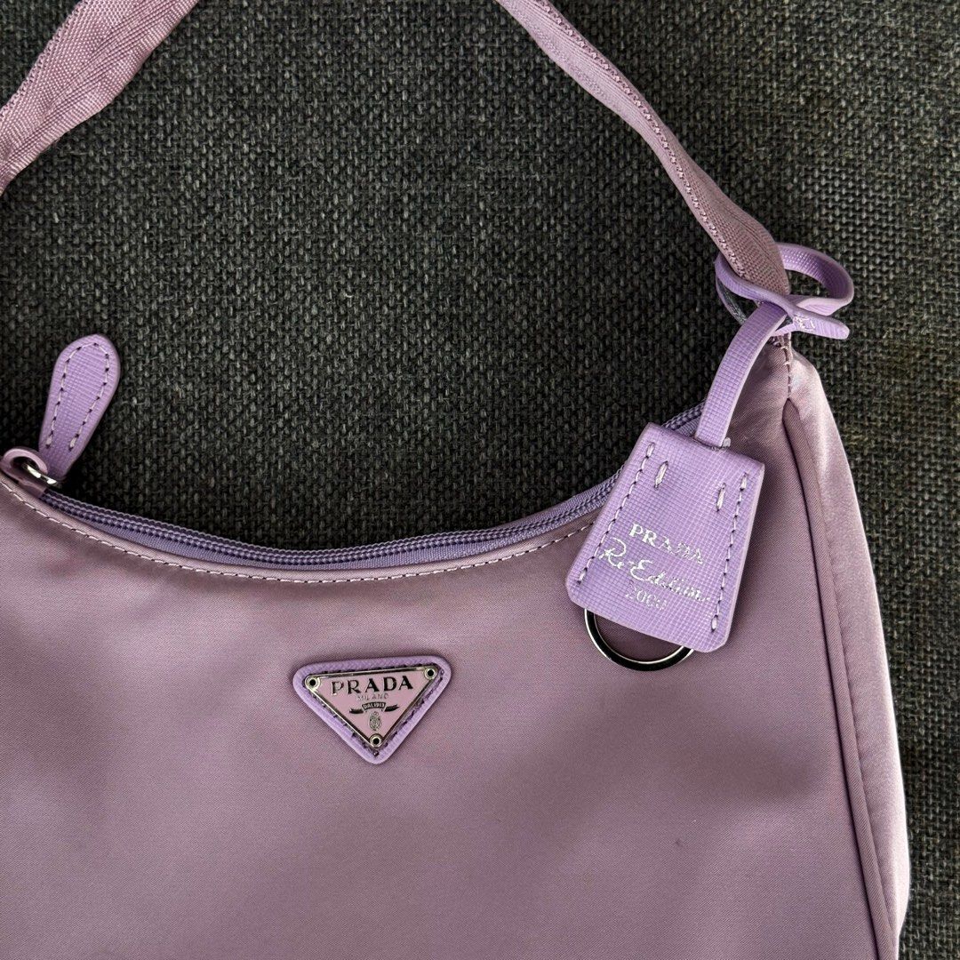 Authentic Prada Tessuto Purple Re-Edition 2005 Nylon Mini Bag (Category: Luxury Bags & Wallets) located in Quezon City. Submitted by lexi.cloud (Listing ID 1426097270, Image 2). Description: SUPER STEAL! ⚜️ guaranteed authentic ⚜️ personal preloved ⚜️ rare color ⚜️ guaranteed authentic ⚜️ minimal signs of usage, barely used ⚜️ 10/10 excellent condition ⚜️ bought from 🇯🇵 ⚜️ no inclusion note: color may vary due to lighting rfs: decluttering MONE