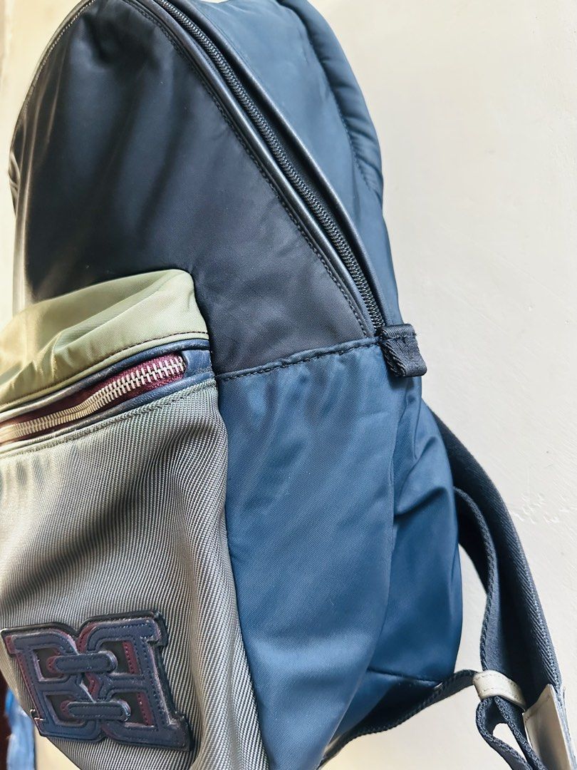 Bally Backpack (Category: Backpacks) located in Subic. Submitted by luxxebrands4less (Listing ID 1426095233, Image 2). Description: - Bally backpack with a multi-tone design - Color scheme: blue, grey, and olive green - Features a front zippered pocket with Bally logo - Adjustable straps for a comfortable fit - Top handle for easy carrying - Main compartment with secure zipper closure.