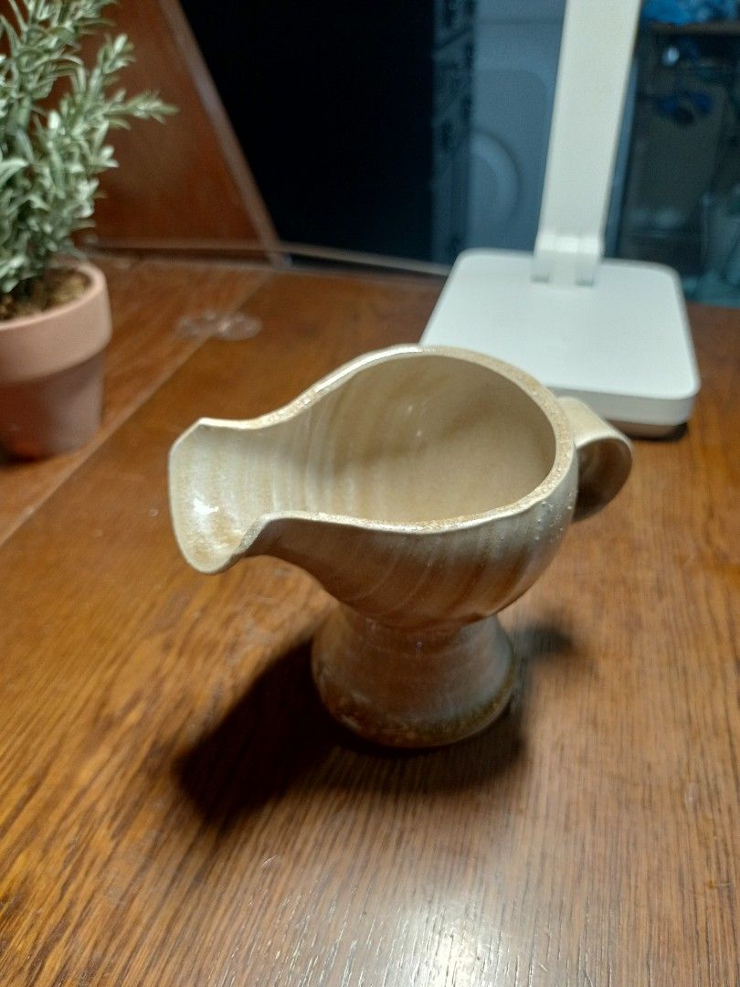Ceramic Pourer with Handle (Category: Pitchers & Dispensers) located in Baguio. Submitted by klutter.curio (Listing ID 1426148431, Image 2). Description: Ceramic pitcher features a unique design with a handle and a spout. It has a light beige color with visible spiral patterns. The pitcher has a wide base and a flared top. Perfect for serving sauces or as a decorative piece..