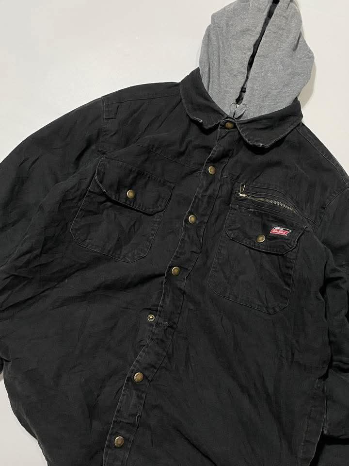 Dickies Hooded Jacket Black (Category: Coats, Jackets and Outerwear) located in Bacoor. Submitted by davealvare39194 (Listing ID 1426071530, Image 3). Description: Black Dickies hooded jacket. Features a gray hood, button-up front, and multiple pockets. The jacket has a quilted lining for added warmth. The size tag indicates a size M/M (38-40)..