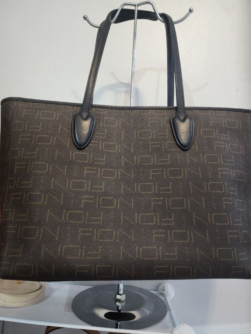 FION Tote Bag with Colorful Perforated Design (Category: Tote Bags) located in Valenzuela. Submitted by cheas077 (Listing ID 1426169270, Image 2). Description: Stylish FION tote bag dino limited edition featuring a unique perforated design with colorful accents. The bag has two sturdy handles and a spacious interior. The interior is lined with a patterned fabric and includes a zippered pocket. The exterior showcases the FION brand name. Perfect f