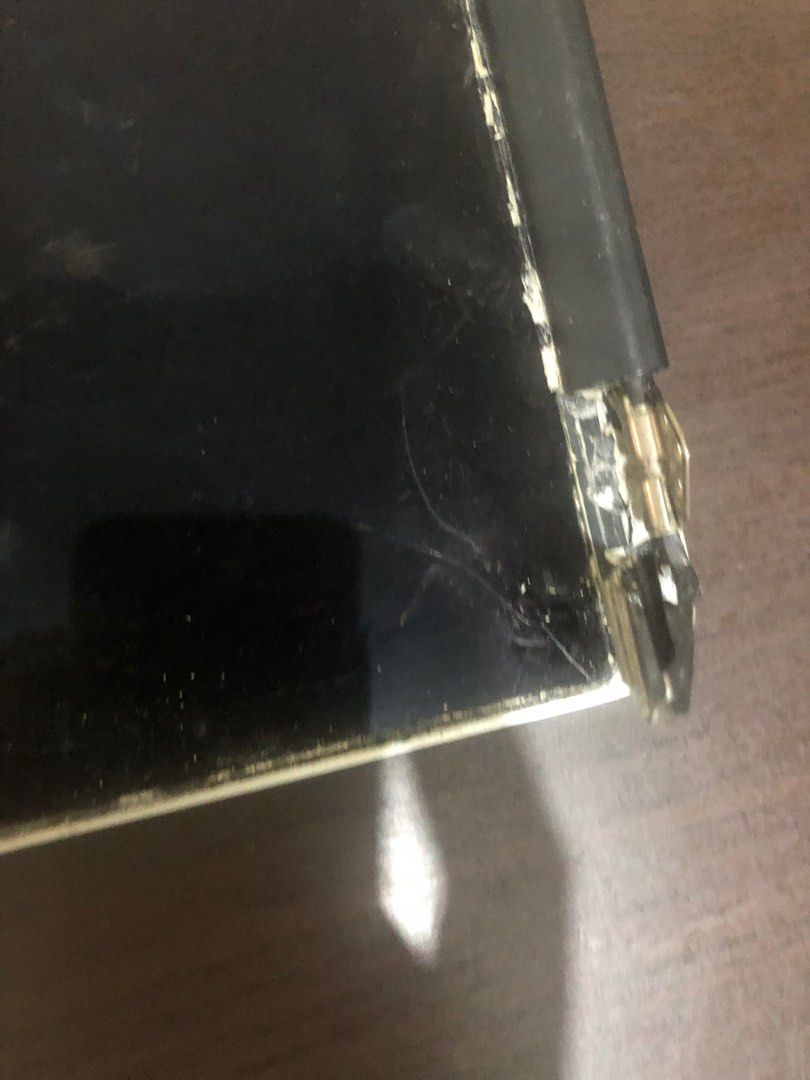 For parts Laptop Screen A1502 (Category: Laptops & Notebooks) located in Pasig City. Submitted by maxscollections (Listing ID 1426152147, Image 3). Description: - Cracked and damaged laptop screen - Visible hinge damage - Screen partially detached from frame - Scratches present - Sold as is Wires can be used as told.