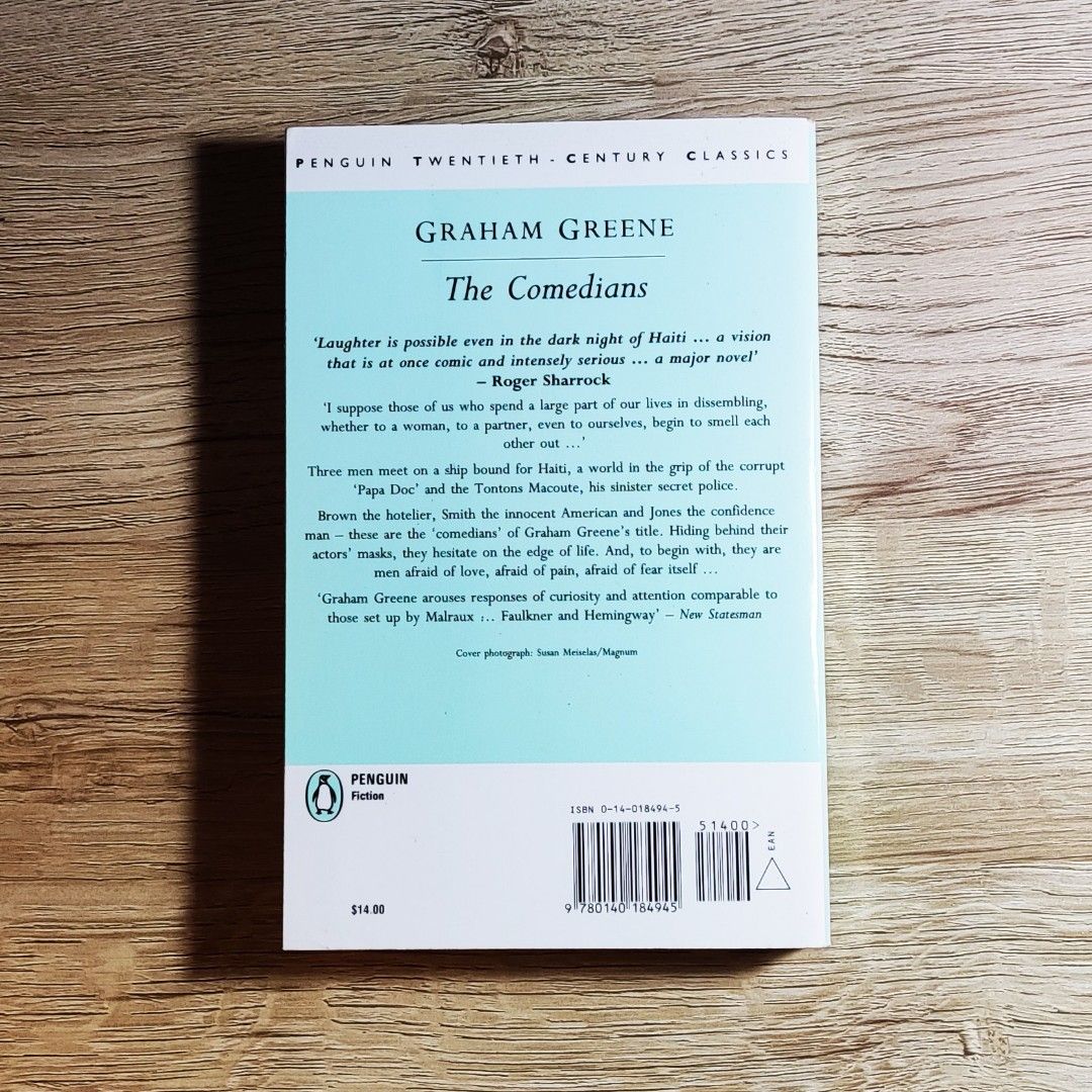 Graham Greene The Comedians (Category: Storybooks) located in Caloocan City. Submitted by animobooks (Listing ID 1426106350, Image 2). Description: Copy of Graham Greene's novel, The Comedians. Published by Penguin Books. The back cover features quotes and a brief synopsis. The book's cover art depicts a black and white image. The price tag shows $14.99. * Normal size Paperback * Penguin Modern Classics * AUTHENTIC BOOK - This is a preloved book.