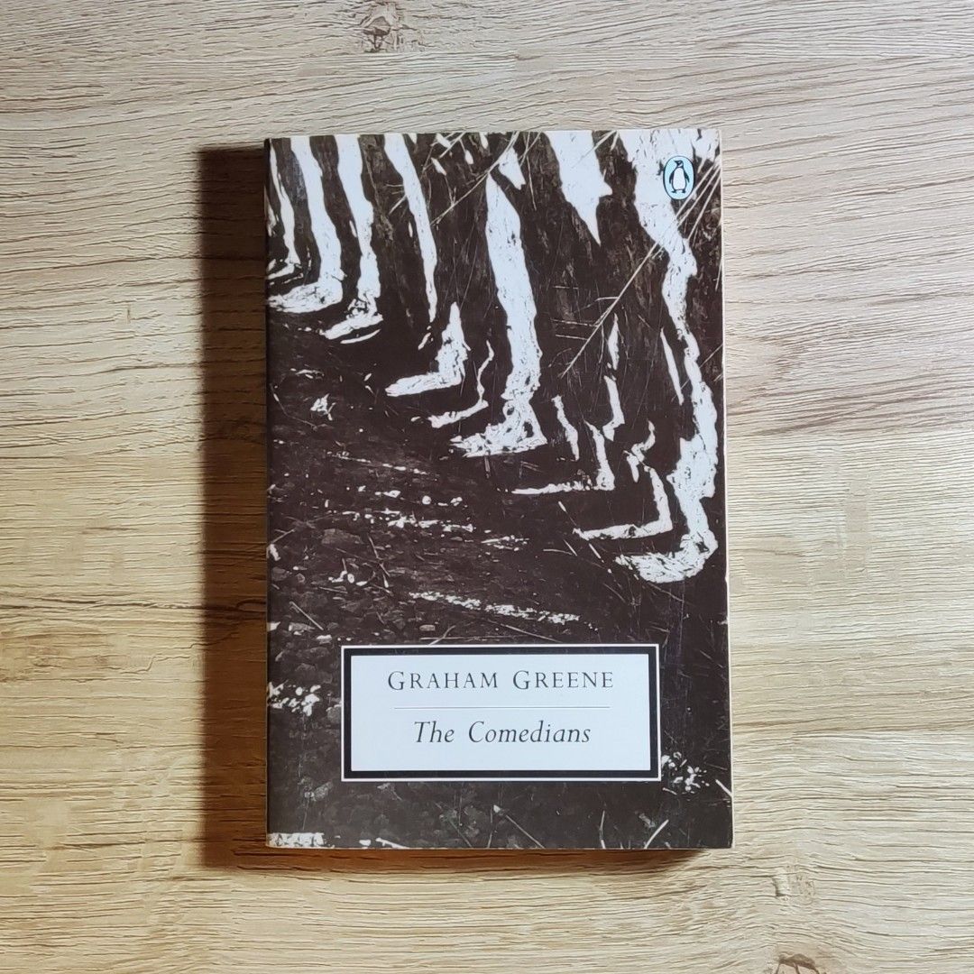 Graham Greene The Comedians (Category: Storybooks) located in Caloocan City. Submitted by animobooks (Listing ID 1426106350, Image 1). Description: Copy of Graham Greene's novel, The Comedians. Published by Penguin Books. The back cover features quotes and a brief synopsis. The book's cover art depicts a black and white image. The price tag shows $14.99. * Normal size Paperback * Penguin Modern Classics * AUTHENTIC BOOK - This is a preloved book.