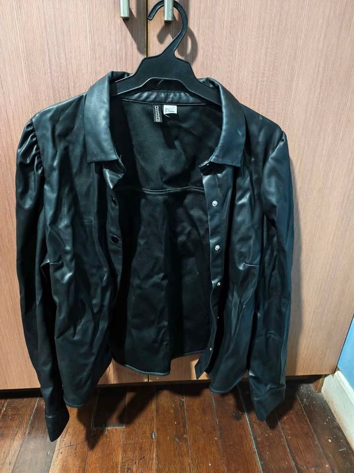H&M Divided Black Faux Leather Jacket (Category: Coats, Jackets and Outerwear) located in Cebu City. Submitted by jacsitems (Listing ID 1426090613, Image 1). Description: H&M faux leather jacket Size L women shoulder width 36cm/14in Torso length 56cm/22in Sleeve length 61cm/24in Waist/torso width 112cm/44in.