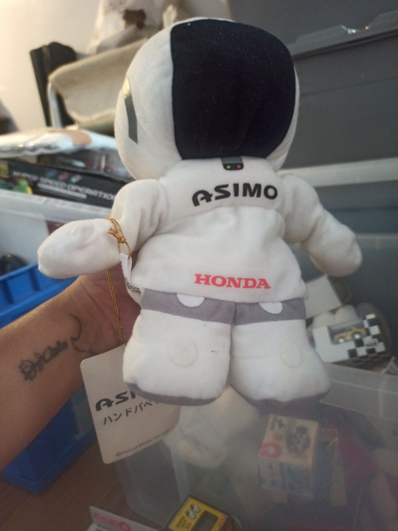 Honda ASIMO (Category: Plushies & Soft Toys) located in Manila. Submitted by avrilarqu43176 (Listing ID 1426063934, Image 1). Description: Honda ASIMO astronaut plush toy. It features the Honda logo and ASIMO printed on the suit. The plush toy is white with a black helmet and gray accents. It has a tag attached. A great collectible item for Honda and ASIMO fans..