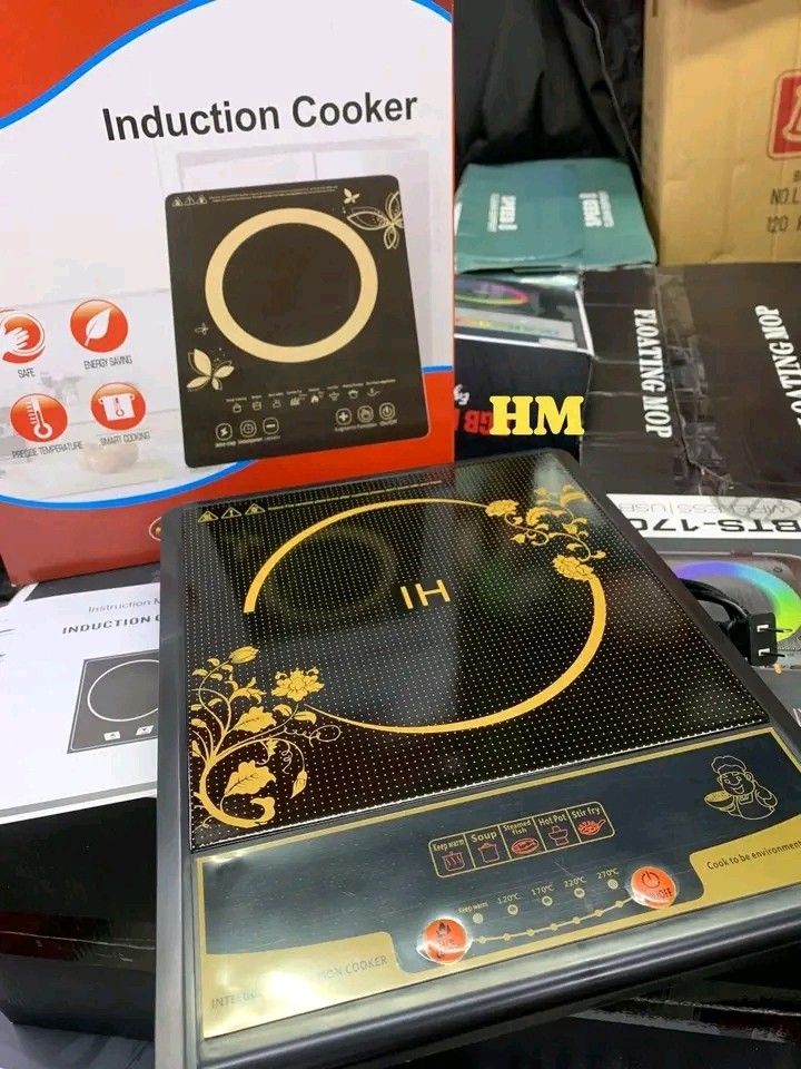 Induction Cooker (Category: Cookers) located in Manila. Submitted by legitseller_angel06 (Listing ID 1426036657, Image 3). Description: Induction cooker features a sleek black design with gold accents. It has multiple cooking settings, including options for hot pot, soup, and frying. The cooker includes a digital display and a power cord. The box indicates it is an "Intelligent Induction Cooker"..