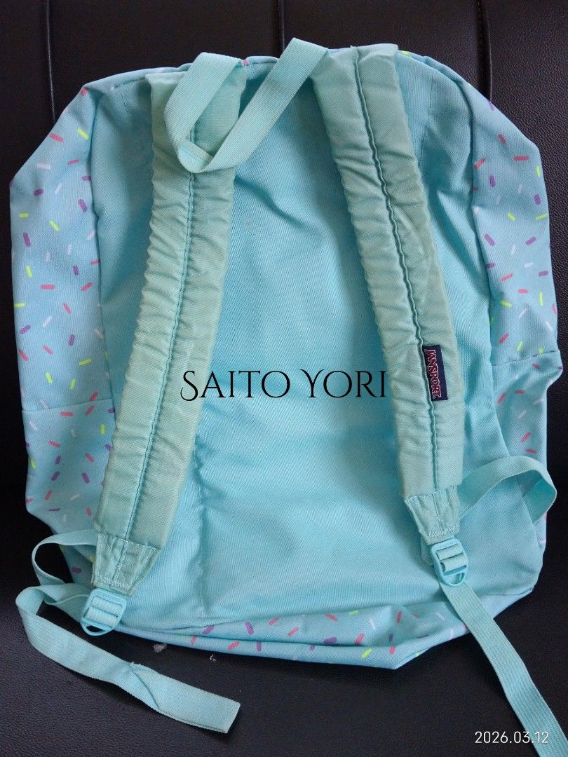 Jansport Unisex Superbreak Blue Topaz Sprinkle Me Backpack (Category: Backpacks) located in Dagupan City. Submitted by saito_yori (Listing ID 1426056104, Image 2). Description: Jansport backpack features a unique sprinkle design. It has a main compartment and a front pocket. The backpack has adjustable shoulder straps for comfortable wear. The interior is a solid turquoise color. The back of the backpack is also turquoise. It has the Jansport log