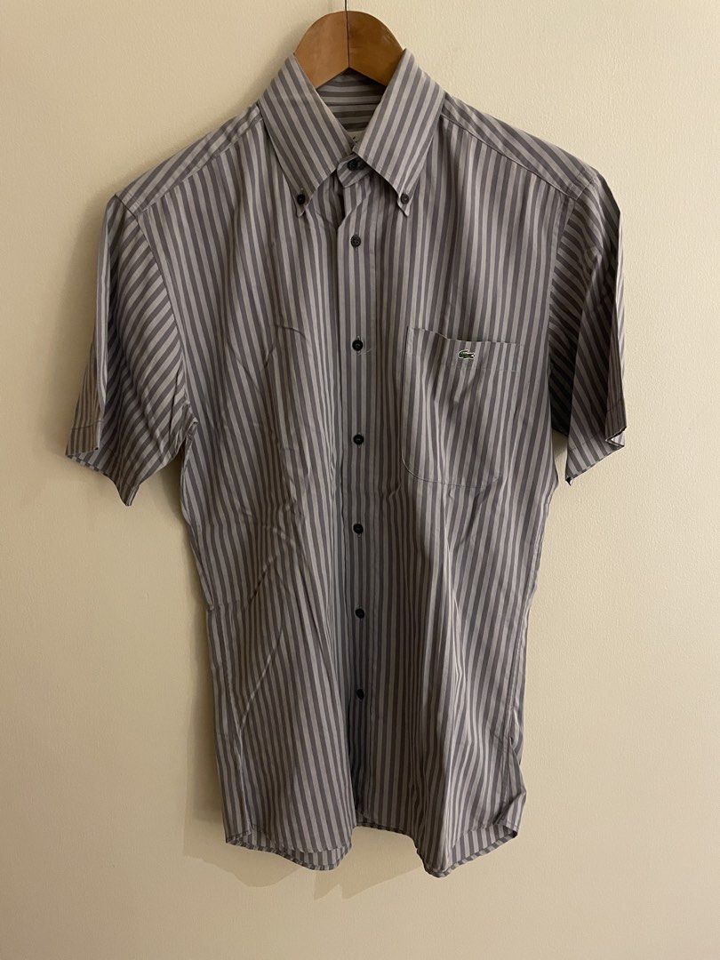 Lacoste Striped Short Sleeve Shirt (Category: Tshirts & Polo Shirts ) located in Makati City. Submitted by LunaMari (Listing ID 1426132936, Image 3). Description: Lacoste short sleeve shirt with a striped pattern. Features a button-down collar and a chest pocket with the Lacoste logo. The shirt has a size 38 label. The buttons also have the Lacoste logo. Made of cotton..