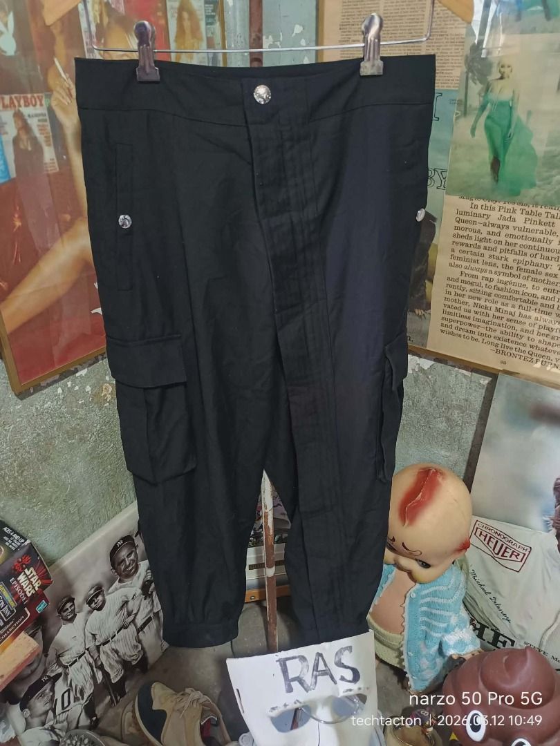 Louis Vuitton Black Cargo Pants diagonal full zip (Category: Luxury Apparel) located in Santo Tomas. Submitted by pickers_corner (Listing ID 1426048037, Image 1). Description: womens cargo pants diagonal full zip missing main brand tag size 40 on tag w28 L34 excellent color rate no holes no stain Black cargo pants from Louis Vuitton. Features multiple pockets and zippers at the ankles. The pants have the Louis Vuitton logo on the buttons and zipp