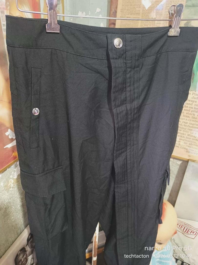 Louis Vuitton Black Cargo Pants diagonal full zip (Category: Luxury Apparel) located in Santo Tomas. Submitted by pickers_corner (Listing ID 1426048037, Image 3). Description: womens cargo pants diagonal full zip missing main brand tag size 40 on tag w28 L34 excellent color rate no holes no stain Black cargo pants from Louis Vuitton. Features multiple pockets and zippers at the ankles. The pants have the Louis Vuitton logo on the buttons and zipp