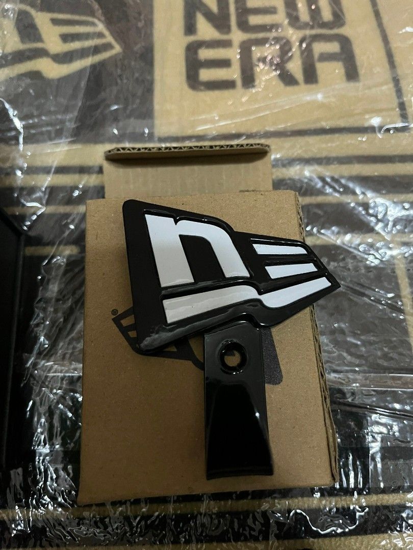 New Era wall hook cap (Category: Everything Else Others) located in Manila. Submitted by armandope (Listing ID 1426056166, Image 1). Description: Genuine New Era car emblem. Features the iconic New Era logo in black and white. Includes the mounting hardware. Perfect for car enthusiasts looking to add a touch of style to their vehicle..