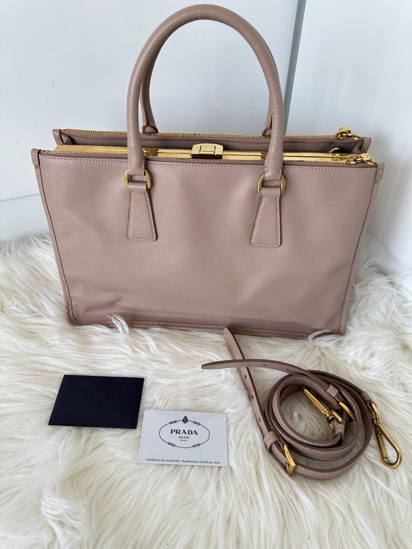Prada Saffiano Lux Cammeo (Category: Luxury Bags & Wallets) located in Cabanatuan. Submitted by matetqqq (Listing ID 1426097111, Image 2). Description: Prada Saffiano Lux Frame Bag features a beautiful blush pink color with gold-tone hardware. It includes a detachable shoulder strap and a frame closure. The bag comes with authenticity cards. The bag has a structured shape and a classic design..