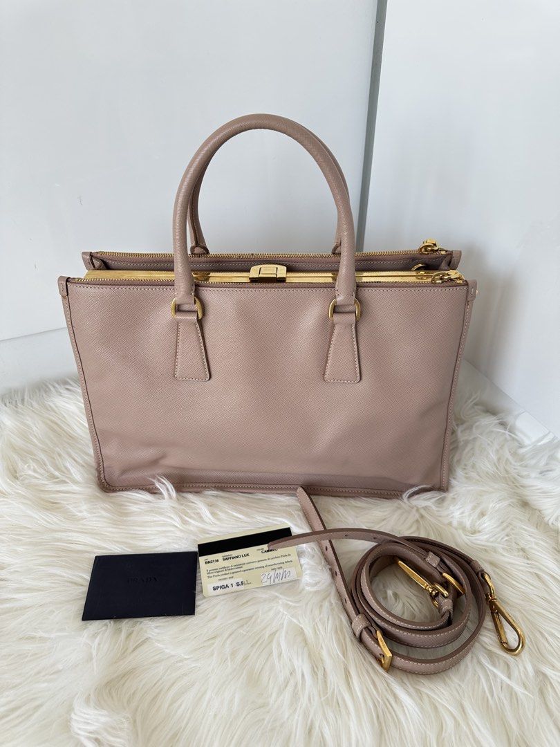 Prada Saffiano Lux Cammeo (Category: Luxury Bags & Wallets) located in Cabanatuan. Submitted by matetqqq (Listing ID 1426097111, Image 1). Description: Prada Saffiano Lux Frame Bag features a beautiful blush pink color with gold-tone hardware. It includes a detachable shoulder strap and a frame closure. The bag comes with authenticity cards. The bag has a structured shape and a classic design..