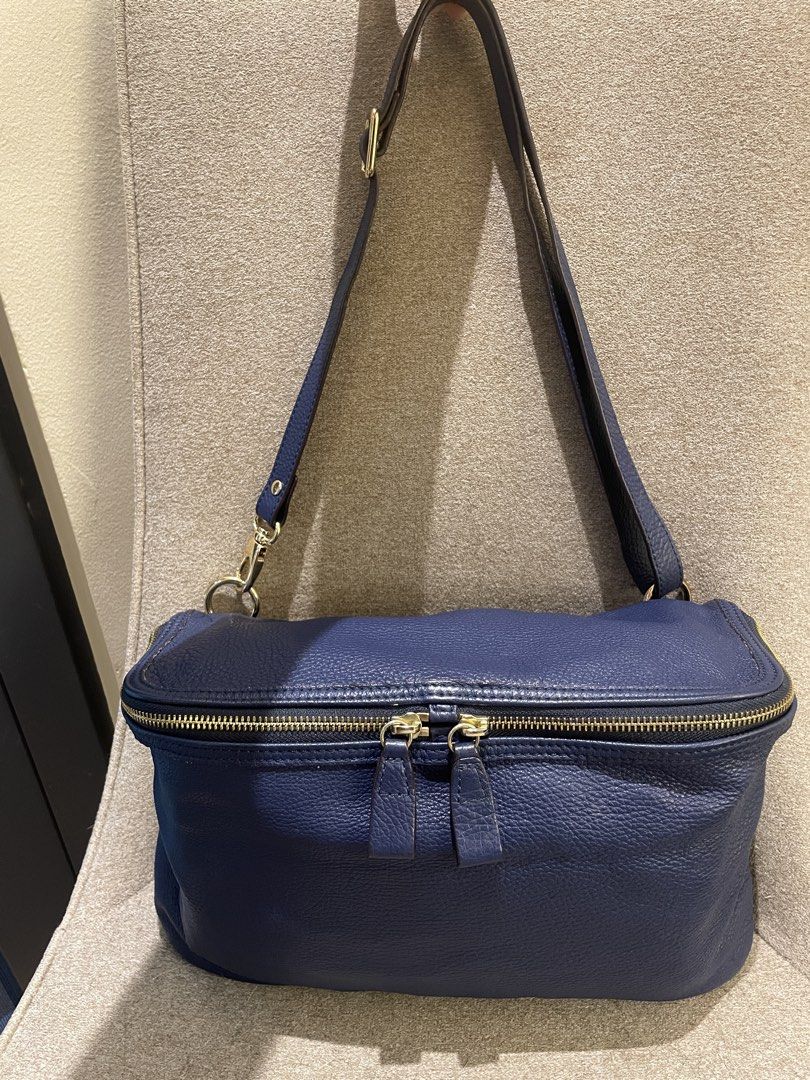 Rabeanco Navy Blue Genuine Leather Shoulder Bag (Category: Shoulder Bags) located in Makati City. Submitted by LunaMari (Listing ID 1426100139, Image 3). Description: Rabeanco shoulder bag is crafted from navy blue leather. It features a top zipper closure with two zipper pulls, a detachable shoulder strap, and gold-tone hardware. Can be worn as a shoulder bag or cross-body. The interior includes a zippered pocket. The bag has the Rabeanco logo o