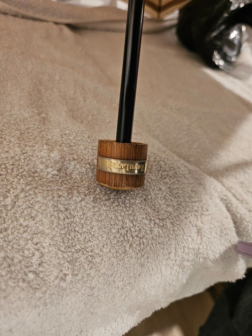 Ralph Lauren Umbrella (Category: Umbrellas) located in Tabuk. Submitted by northern_luxury (Listing ID 1426005537, Image 2). Description: Ralph Lauren umbrella features a tan and brown checkered pattern. The handle is made of wood with a gold-colored band that has the brand name. The umbrella has a classic design with a sturdy frame. It is a stylish accessory for sun or rain. nasa pic po ang flaw. it comes with a case.
