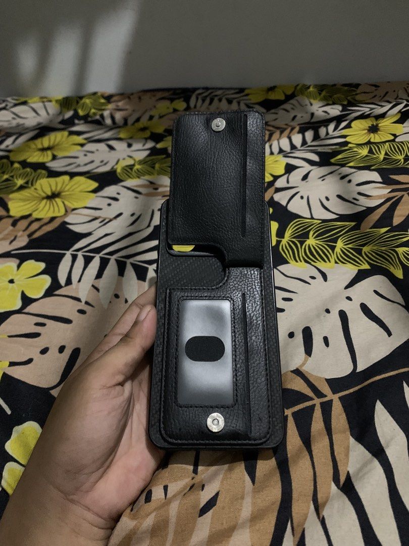 Realme Narzo 5i Wallet Phone Case - Black Textured Design (Category: Cases & Sleeves) located in San Juan, La Union. Submitted by declutteringog7 (Listing ID 1426147828, Image 1). Description: Practical wallet-style case for Realme Narzo 5i. Features a textured exterior, zippered pocket for cash/coins, and a card slot with a clear ID window. All parts work perfectly – no tears, scratches, or broken zippers. Great for keeping essentials in one pla