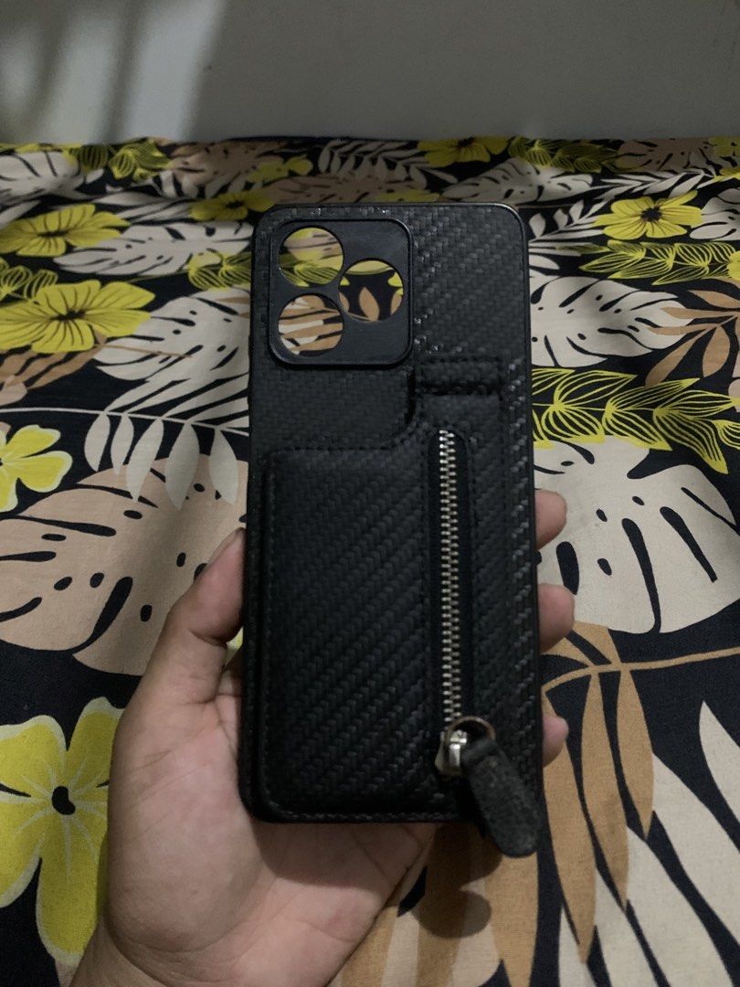 Realme Narzo 5i Wallet Phone Case - Black Textured Design (Category: Cases & Sleeves) located in San Juan, La Union. Submitted by declutteringog7 (Listing ID 1426147828, Image 2). Description: Practical wallet-style case for Realme Narzo 5i. Features a textured exterior, zippered pocket for cash/coins, and a card slot with a clear ID window. All parts work perfectly – no tears, scratches, or broken zippers. Great for keeping essentials in one pla