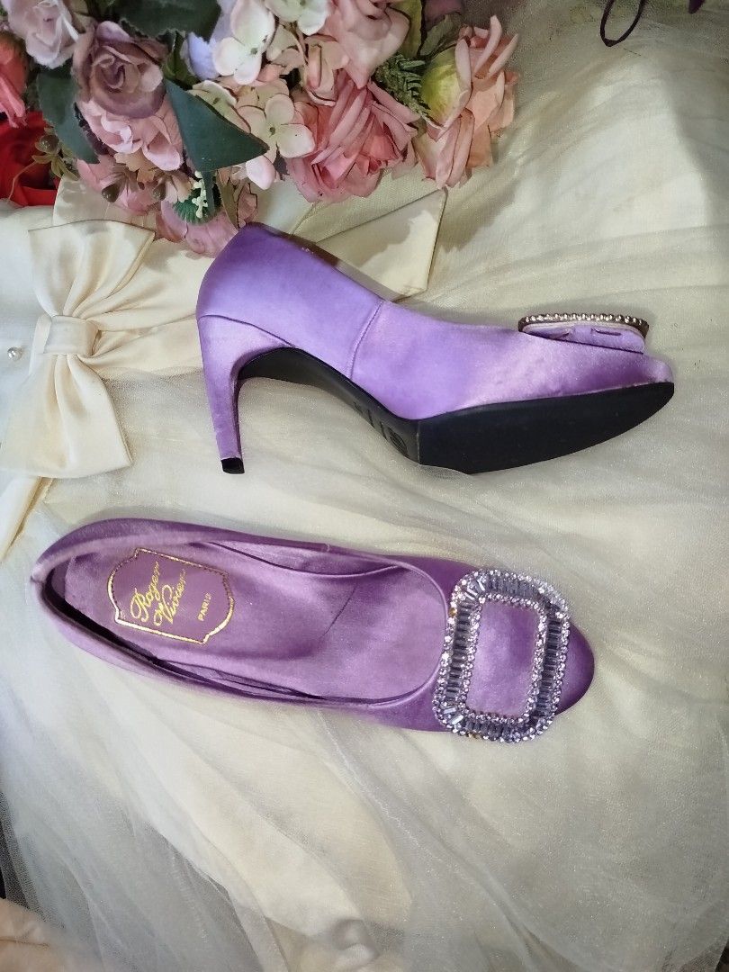Roger Vivier Purple Satin Heels (Category: Sneakers & Footwear) located in San Fernando. Submitted by la_segunda2727 (Listing ID 1426105606, Image 3). Description: Elegant RV heels in a beautiful purple satin. Features a sparkling rectangular buckle detail. The heels have a semi- pointed toe and a slender heel. The soles indicate a size 38. Perfect for special occasions or adding a touch of glamour to any outfit..