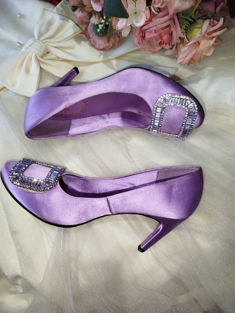 Roger Vivier Purple Satin Heels (Category: Sneakers & Footwear) located in San Fernando. Submitted by la_segunda2727 (Listing ID 1426105606, Image 1). Description: Elegant RV heels in a beautiful purple satin. Features a sparkling rectangular buckle detail. The heels have a semi- pointed toe and a slender heel. The soles indicate a size 38. Perfect for special occasions or adding a touch of glamour to any outfit..