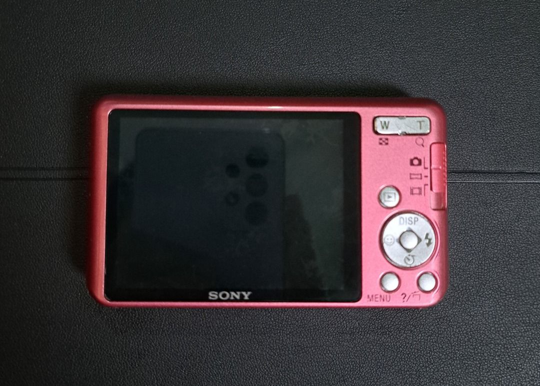 Sony Cyber-shot dsc w630 Digital Camera (Category: Cameras) located in Zamboanga. Submitted by khanhadjir07637 (Listing ID 1426113922, Image 2). Description: Pink Sony Cyber-shot digital camera with Carl Zeiss lens. Features 16.1 megapixels. Includes a camera case and wrist strap. The camera has a screen on the back with control buttons. The camera is pink. Issue: no flash at need tape battdoor.