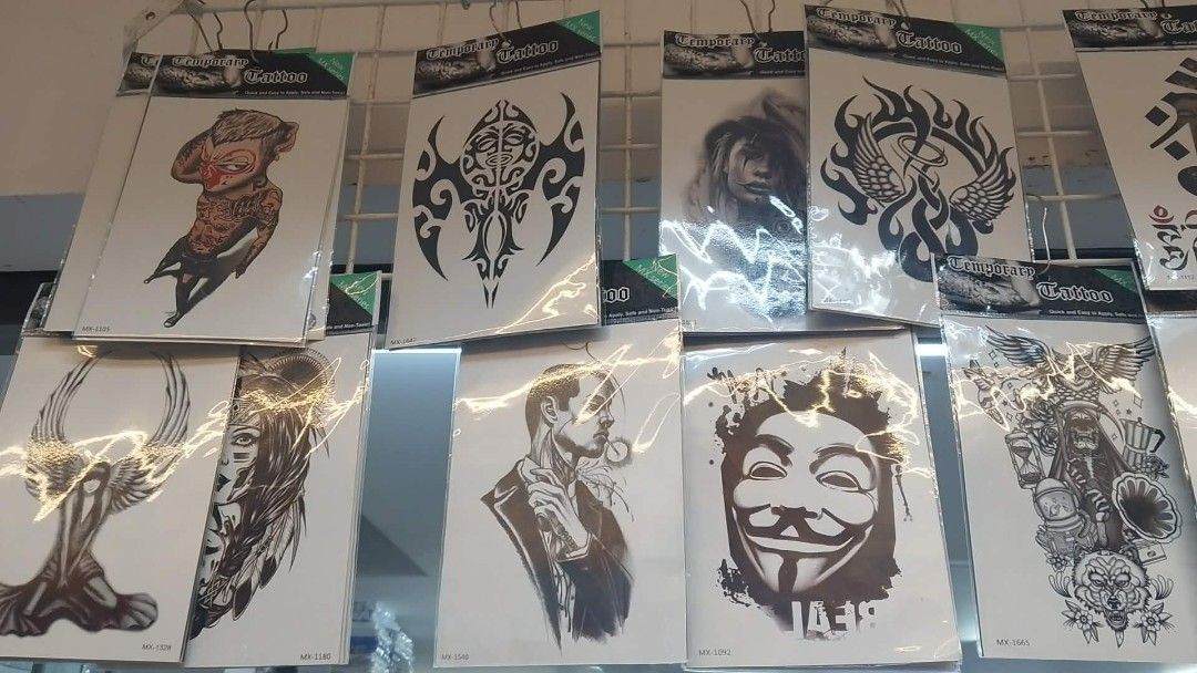 Temporary Tattoo Assortment - Various Designs (Category: Art & Prints) located in Manila. Submitted by neojamesca55018 (Listing ID 1426182170, Image 3). Description: Wide variety of temporary tattoos featuring diverse designs. Includes images of eagles, hands, roses, anime characters, and tribal patterns. Each tattoo is individually packaged. Designs include both black and white and colored options. Perfect for adding some flair to your look. Gre