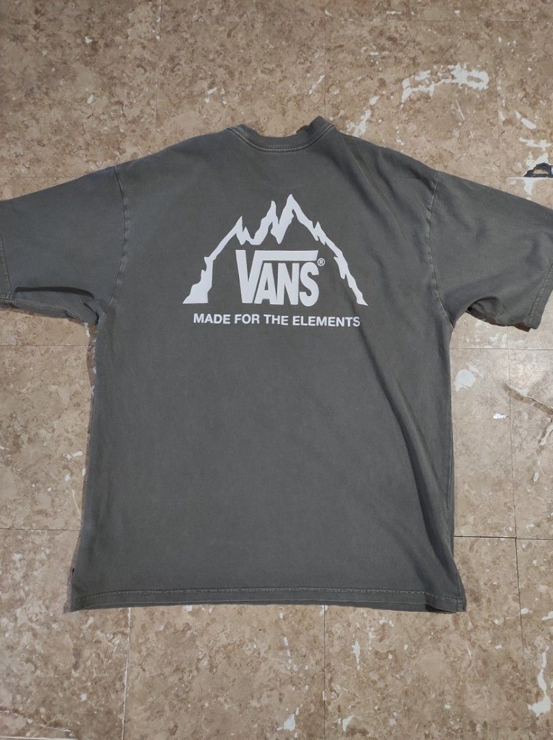 Vans Made For The Elements Loose Fit T-Shirt (Category: Tshirts & Polo Shirts ) located in Las Pinas. Submitted by jeusmanlangit (Listing ID 1426110293, Image 2). Description: VANS MADE FOR THE ELEMENTS LOOSE FIT -Vans t-shirt features a mountain graphic on the back and a small logo on the front. -It is a loose fit, size large. -The shirt is a muted green color. -The tag indicates it is made of organic cotton. -The Vans logo is also visible on th