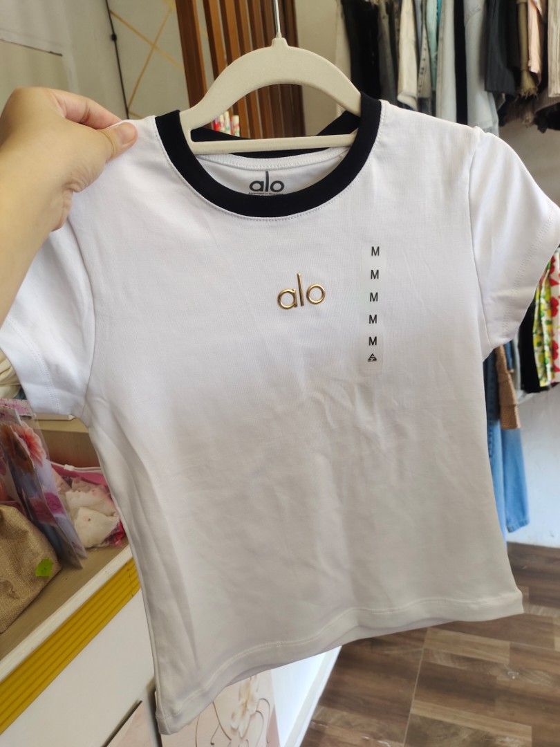 Alo Short Sleeve T-shirts (Category: Shirts) located in Cabanatuan. Submitted by shoppbbykk (Listing ID 1426201009, Image 2). Description: These Alo Yoga short sleeve t-shirts are available in multiple colors. The shirts feature the Alo logo on the front. The shirts have a crew neck design. The available colors are white, pink, black, and gray. The shirts have a minimalist design, perfect for everyday wear or workouts..