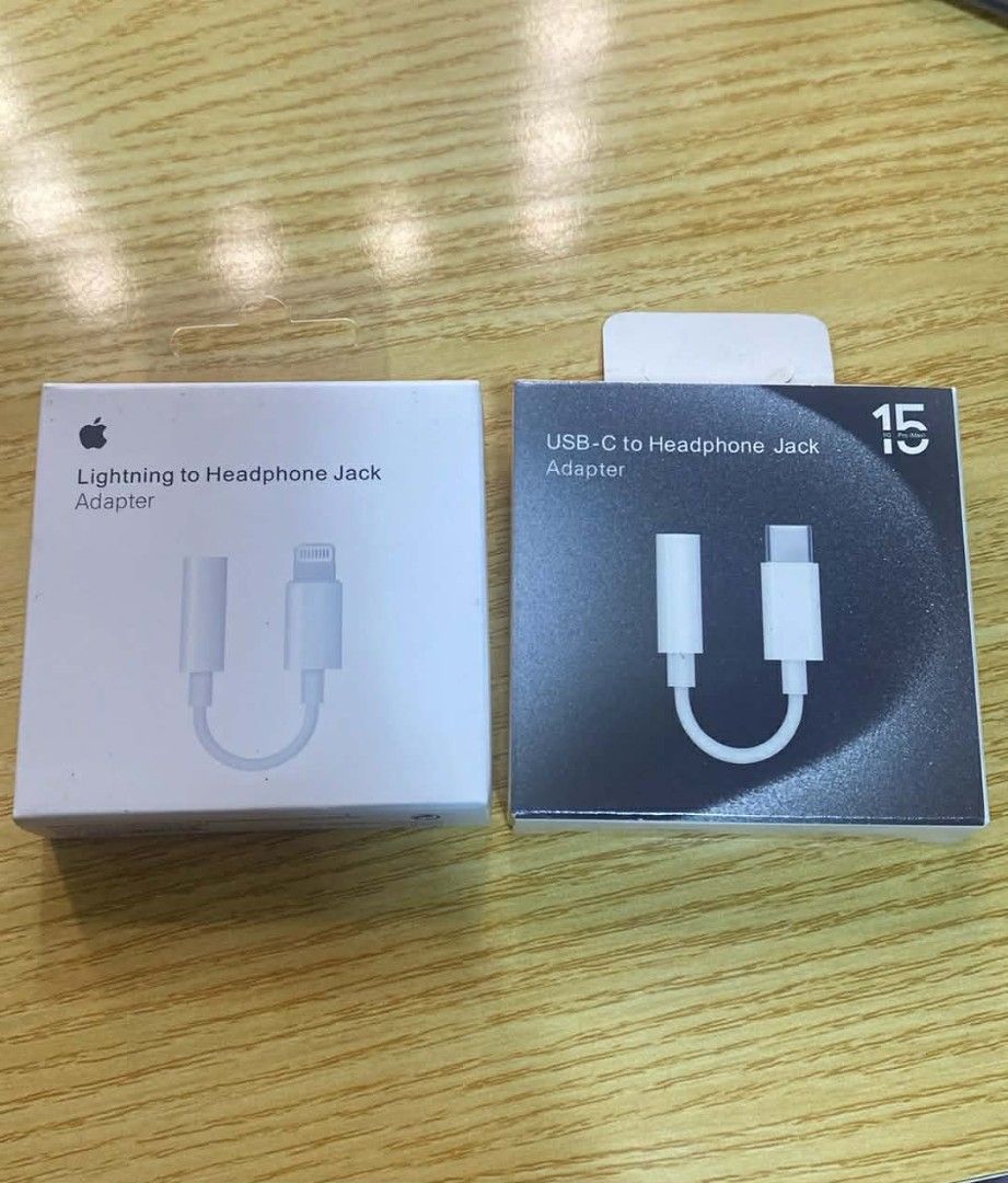 Apple Lightning to Headphone Jack Adapter & USB-C Adapter (Category: Chargers & Cables) located in Manila. Submitted by milasgadgetph (Listing ID 1426301874, Image 1). Description: Includes two Apple adapters: a Lightning to Headphone Jack Adapter and a USB-C to Headphone Jack Adapter. Both are in their original packaging. The Lightning adapter allows you to connect headphones with a 3.5mm jack to your iPhone or other devices with a Lightning por
