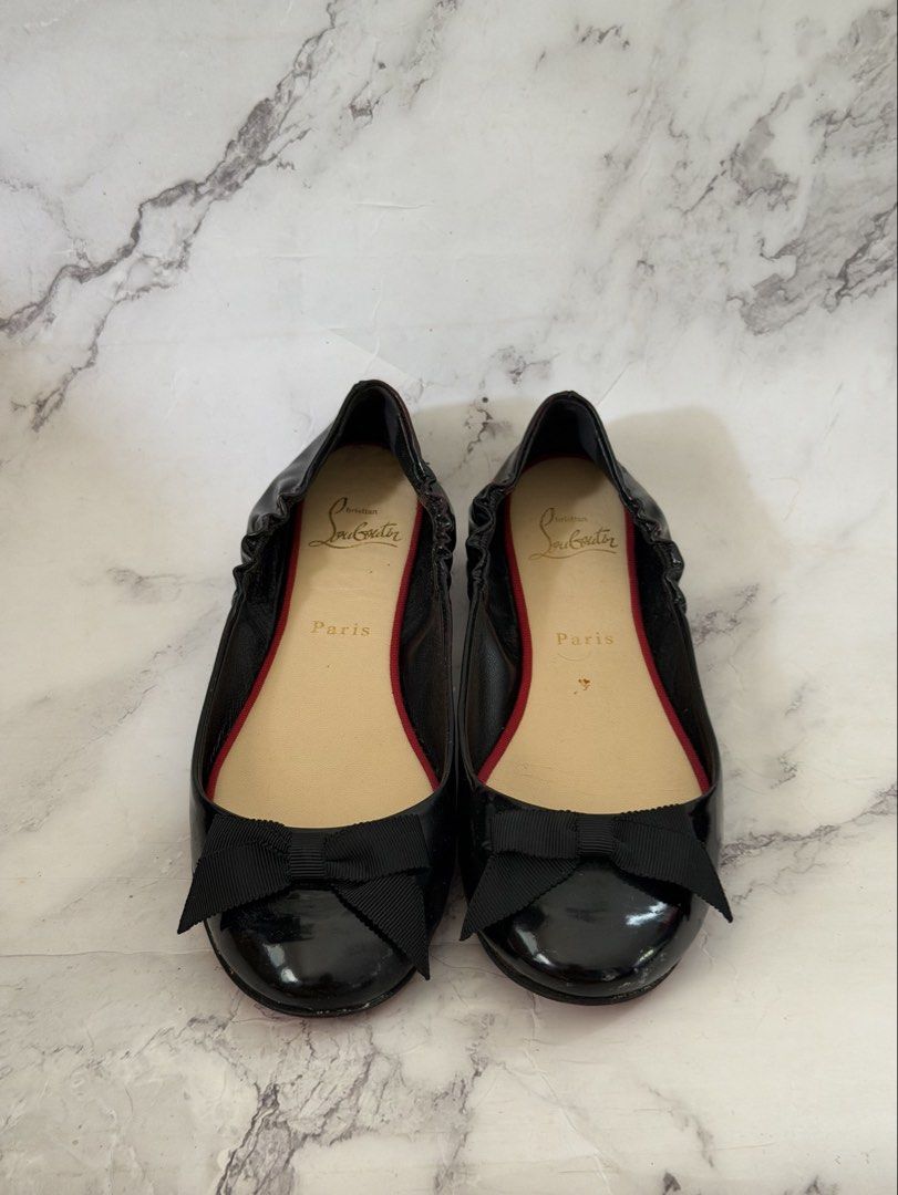 Authentic Christian Louboutin Black Flats (Category: Sneakers & Footwear) located in Davao. Submitted by gatrading (Listing ID 1426311690, Image 2). Description: - Christian Louboutin black flats - Features a bow detail - Includes original box and dust bag - Signature red soles.