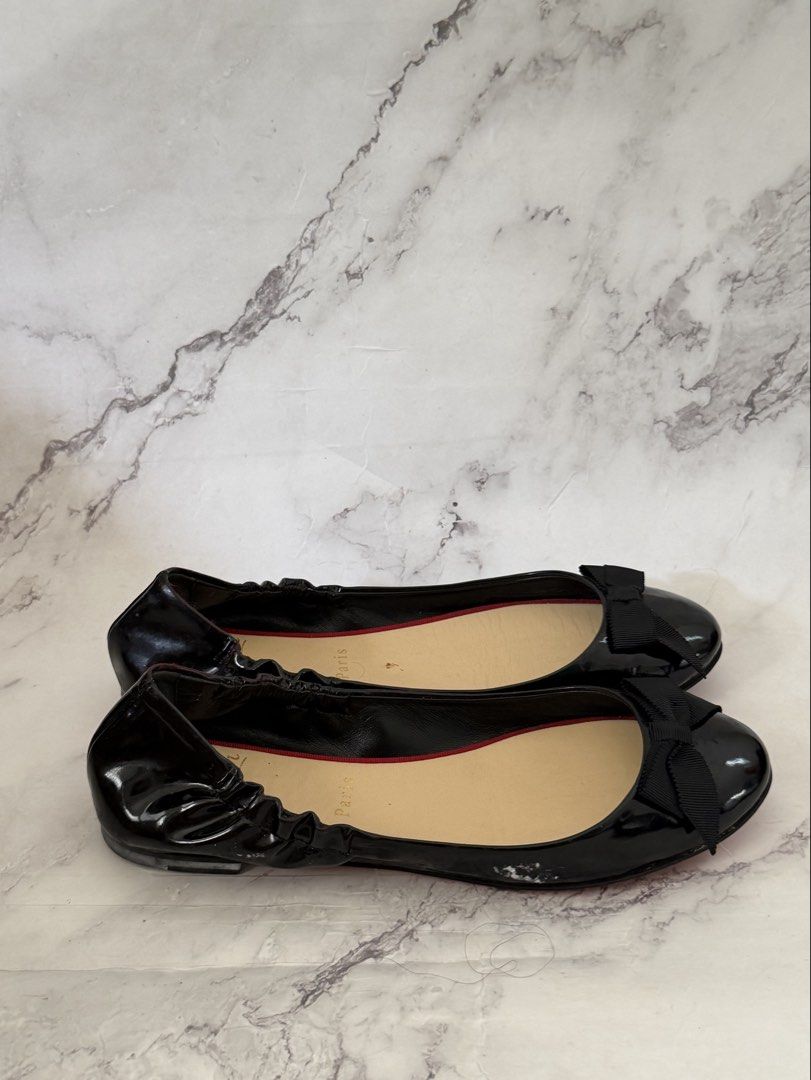 Authentic Christian Louboutin Black Flats (Category: Sneakers & Footwear) located in Davao. Submitted by gatrading (Listing ID 1426311690, Image 3). Description: - Christian Louboutin black flats - Features a bow detail - Includes original box and dust bag - Signature red soles.