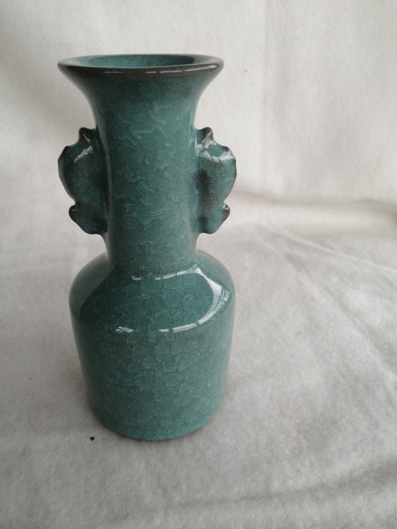 Celadon Glazed Vase with Handles Japan (Category: Vases & Decorative Bowls) located in Liloan. Submitted by aidolcapz88 (Listing ID 1426154322, Image 1). Description: Beautiful celadon glazed vase. Features a unique shape with two handles. The vase has a crackle glaze effect. The base has a marking. A decorative piece that can add a touch of elegance to any space.Ang mahal pala nito. Size 8"height.