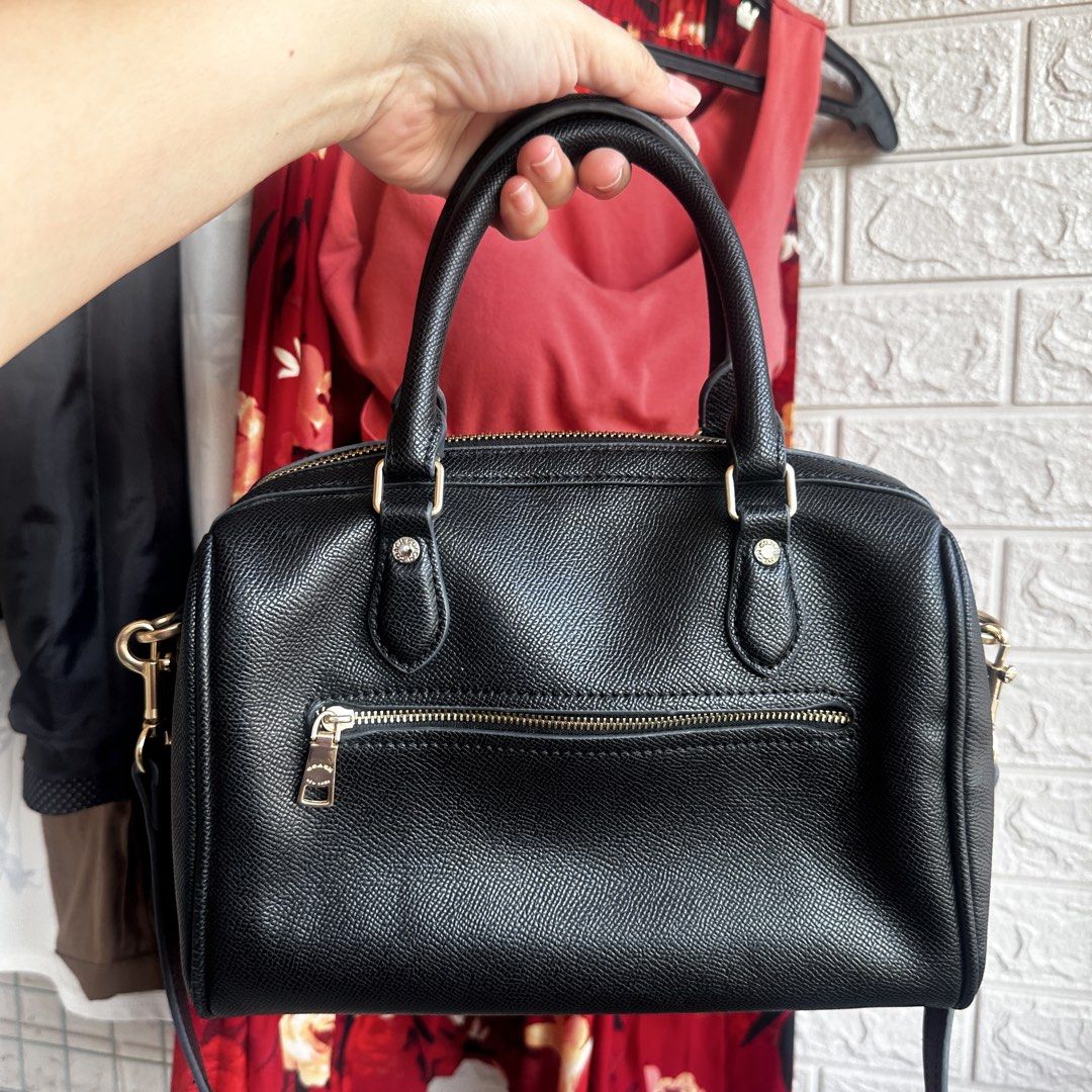 Coach Black Leather Satchel Bag (Category: Luxury Bags & Wallets) located in Cebu City. Submitted by k_and_k_pinkcloset (Listing ID 1426204869, Image 2). Description: Black Coach satchel bag with gold-tone hardware. Features dual top handles and a detachable shoulder strap. The interior includes a slip pocket and a Coach authenticity patch. Made in Vietnam. Includes a Coach hang tag. The bag has a zip closure and a zip pocket on the back..
