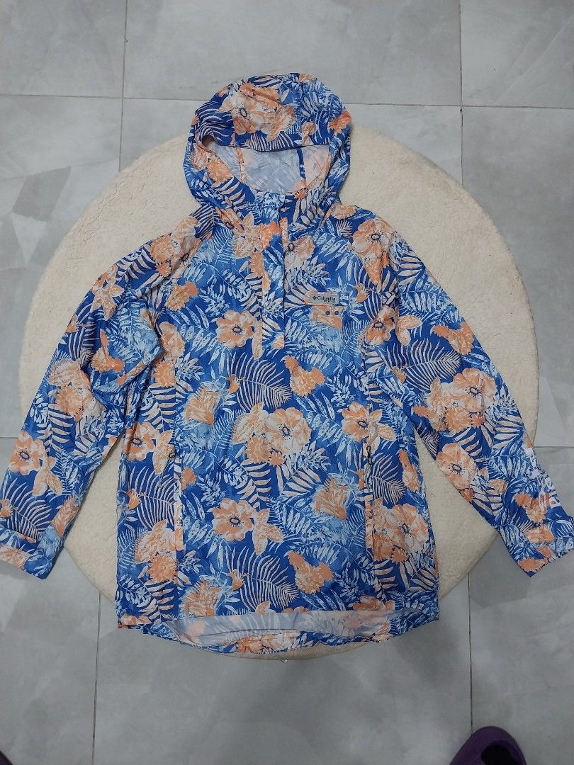 Columbia Floral Print Jacket (Category: Coats, Jackets and Outerwear) located in Malaybalay. Submitted by markdaumar08466 (Listing ID 1426216606, Image 1). Description: Columbia jacket features a vibrant floral print in blue and orange. It has a hood and a drawstring. The Columbia logo is visible on the inside. The jacket is suitable for outdoor activities..