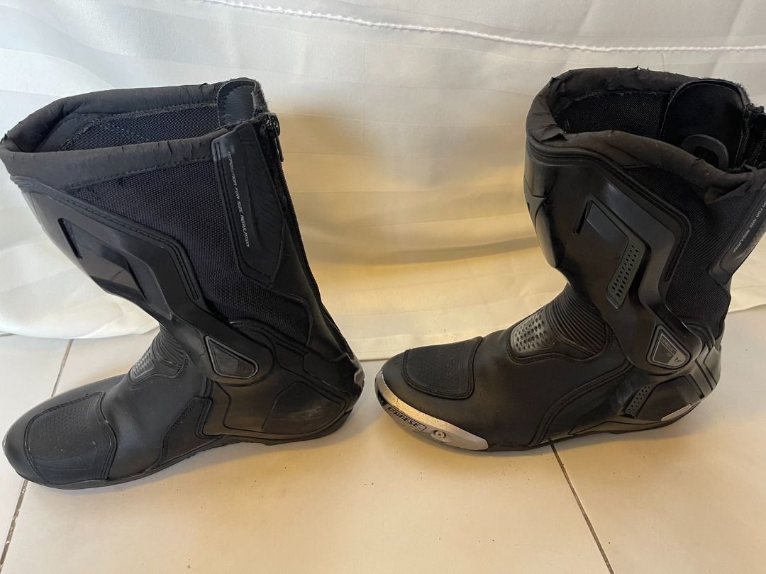 Dainese Torque D1 Out Boots (Category: Boots) located in Muntinlupa City. Submitted by execoffic56216 (Listing ID 1426245226, Image 3). Description: Black Dainese Torque D1 Out motorcycle boots. Features a zipper closure on the back and Dainese logo on the side. The boots have some wear and tear on the top edges. Includes size information on the inside of the boots. NEGOTIABLE!!.