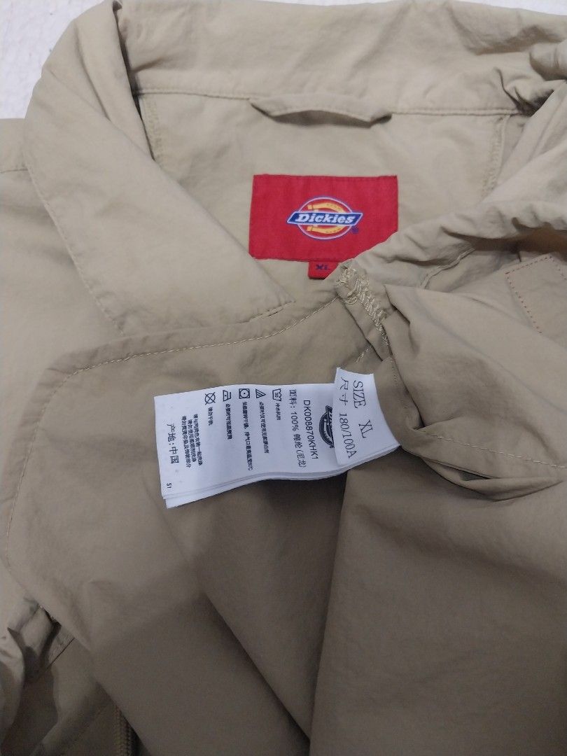 Dickies Jacket XL (Category: Coats, Jackets and Outerwear) located in Malaybalay. Submitted by markdaumar08466 (Listing ID 1426216303, Image 3). Description: Khaki Dickies jacket. Features a button-up front, collar, and the Dickies logo on the front and back. The jacket has a red Dickies patch on the front. Size XL. Made of 100% polyester..