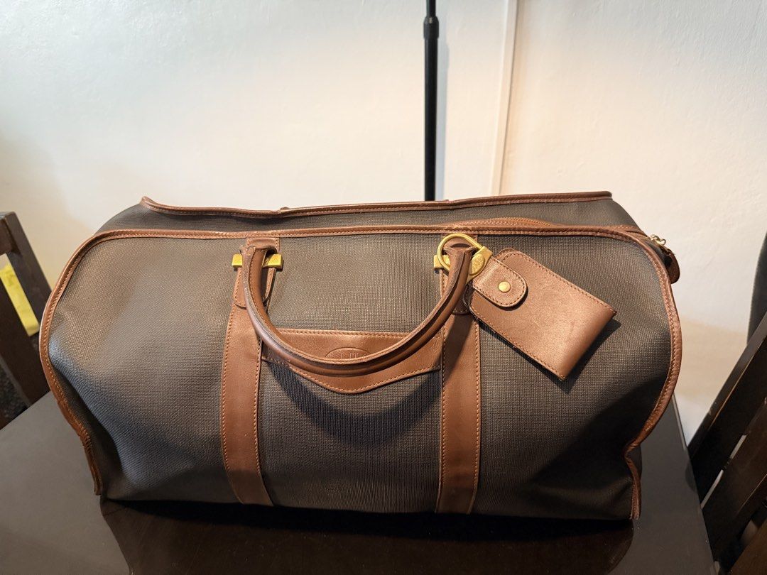 Dunhill Duffle Bag with Leather Accents (Category: Luxury Bags & Wallets) located in Cainta. Submitted by randomstuff29 (Listing ID 1426362384, Image 1). Description: Condition:8/10 w/ bag tag, lock & key L19.5” H10” W11” .
