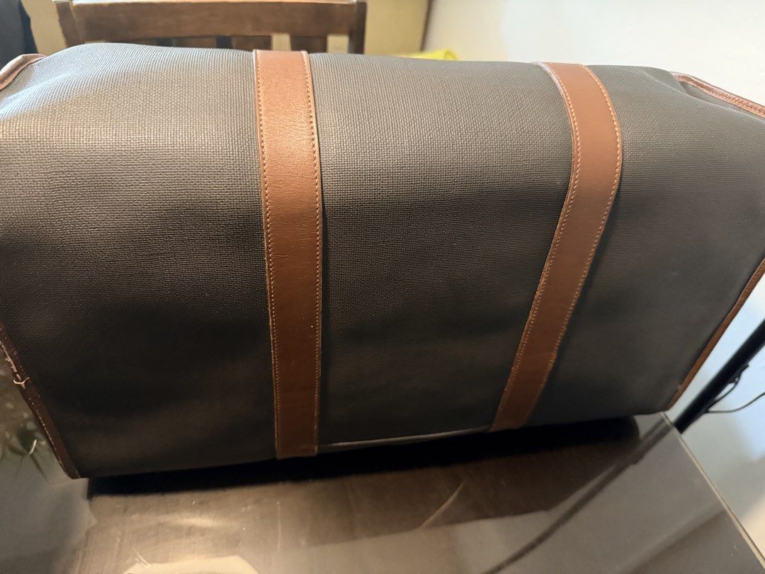 Dunhill Duffle Bag with Leather Accents (Category: Luxury Bags & Wallets) located in Cainta. Submitted by randomstuff29 (Listing ID 1426362384, Image 2). Description: Condition:8/10 w/ bag tag, lock & key L19.5” H10” W11” .