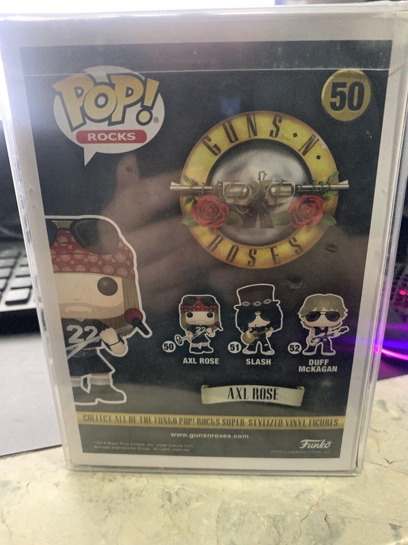 Funko Pop! Rocks Axl Rose #50 (Category: Figurines & Statues) located in Manila. Submitted by robertzombie (Listing ID 1426241339, Image 3). Description: Funko Pop! Rocks figure features Axl Rose from Guns N' Roses. It is number 50 in the series. The figure is in its original packaging. The box shows Axl Rose wearing a bandana and holding a microphone. The back of the box shows other figures in the series, including Slash and Duff McKagan. contac