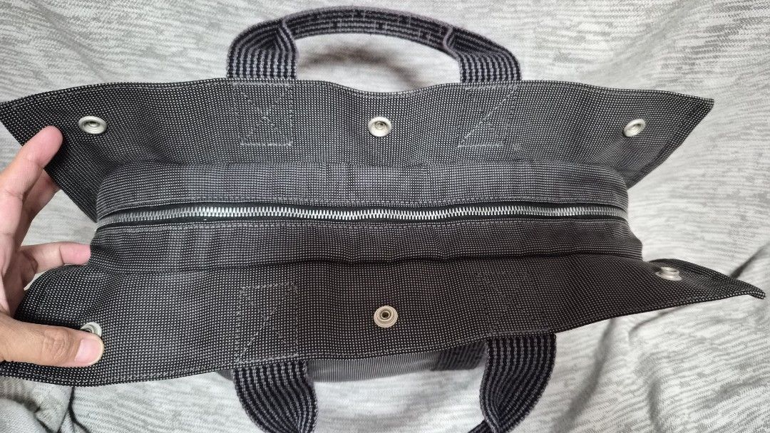 Hermes Herline Canvas Tote Bag (Category: Luxury Bags & Wallets) located in Quezon City. Submitted by marya_s (Listing ID 1426284821, Image 2). Description: firm price wag na po magmessage if kulang budget free shipping via J&T Handle Drop: 3.5" Height: 13" Width: 17.25" Depth: 4" Lock has no key Black tote bag with a zipper closure. It features a woven pattern and two handles. The bag includes a lock and a tag with the Hermes-Paris logo. The int