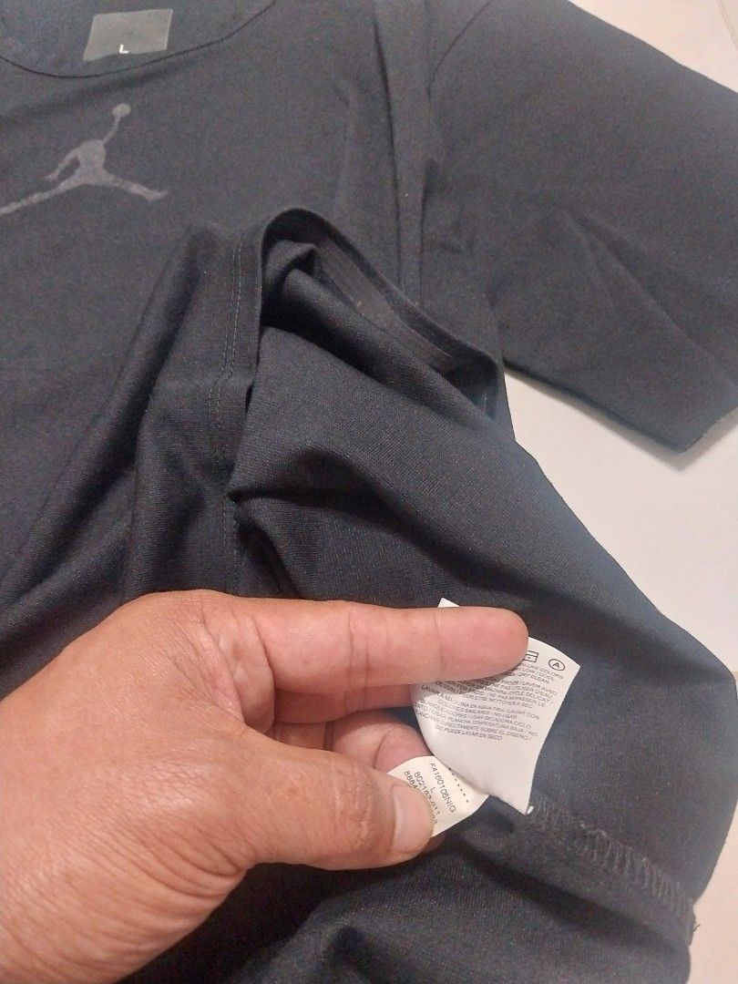 Jordan Black T-shirt - Size L (Category: Tshirts & Polo Shirts ) located in Malaybalay. Submitted by markdaumar08466 (Listing ID 1426301236, Image 2). Description: Black Jordan t-shirt. Features the iconic Jumpman logo on the chest and the brand name on the sleeve. The size is Large. Made with a breathable fabric, suitable for sports or casual wear. The tag is visible in the image. A versatile addition to any wardrobe..