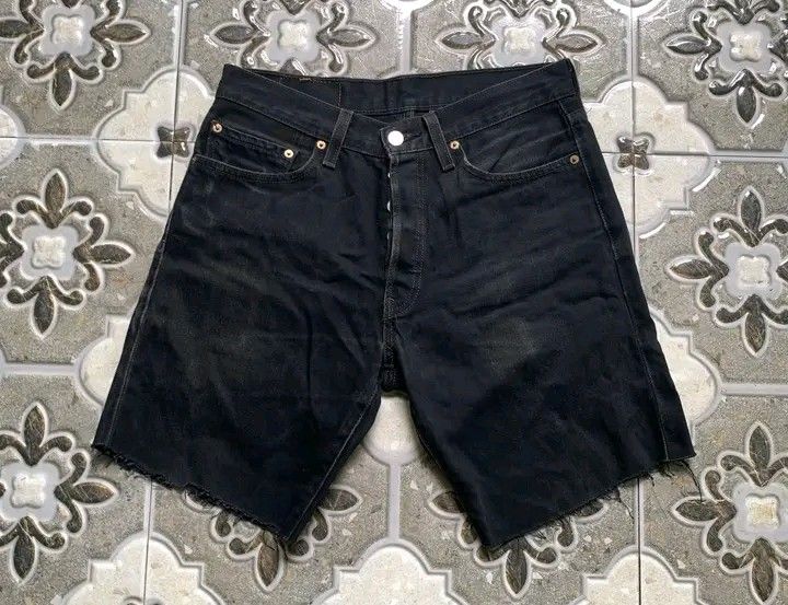 Levi's 501 Black Denim Shorts (Category: Shorts) located in Butuan. Submitted by markystuffs23 (Listing ID 1426372666, Image 1). Description: Authentic Levi's 501 black denim shorts. Features a button fly and the classic Levi's red tab on the back pocket. The shorts have a raw hem. The size is 31x32. The shorts have a vintage look..