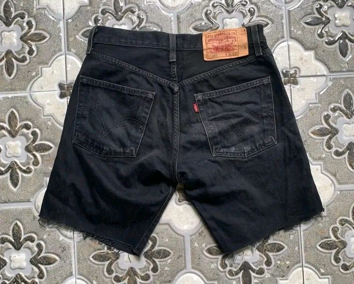 Levi's 501 Black Denim Shorts (Category: Shorts) located in Butuan. Submitted by markystuffs23 (Listing ID 1426372666, Image 2). Description: Authentic Levi's 501 black denim shorts. Features a button fly and the classic Levi's red tab on the back pocket. The shorts have a raw hem. The size is 31x32. The shorts have a vintage look..